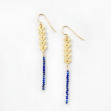Free Spirit Earrings with small gemstones and a sleek design with gold arrow accents and catching the sunlight while hanging 2 inches. Lightweight earrings that are great for everyday and come in lapis, ruby, pearl, and black spinel.